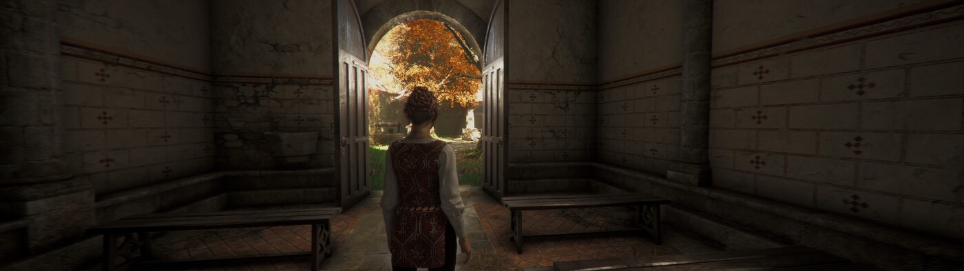 Woman in a tunic inside a building looking out a door into a garden in autumn