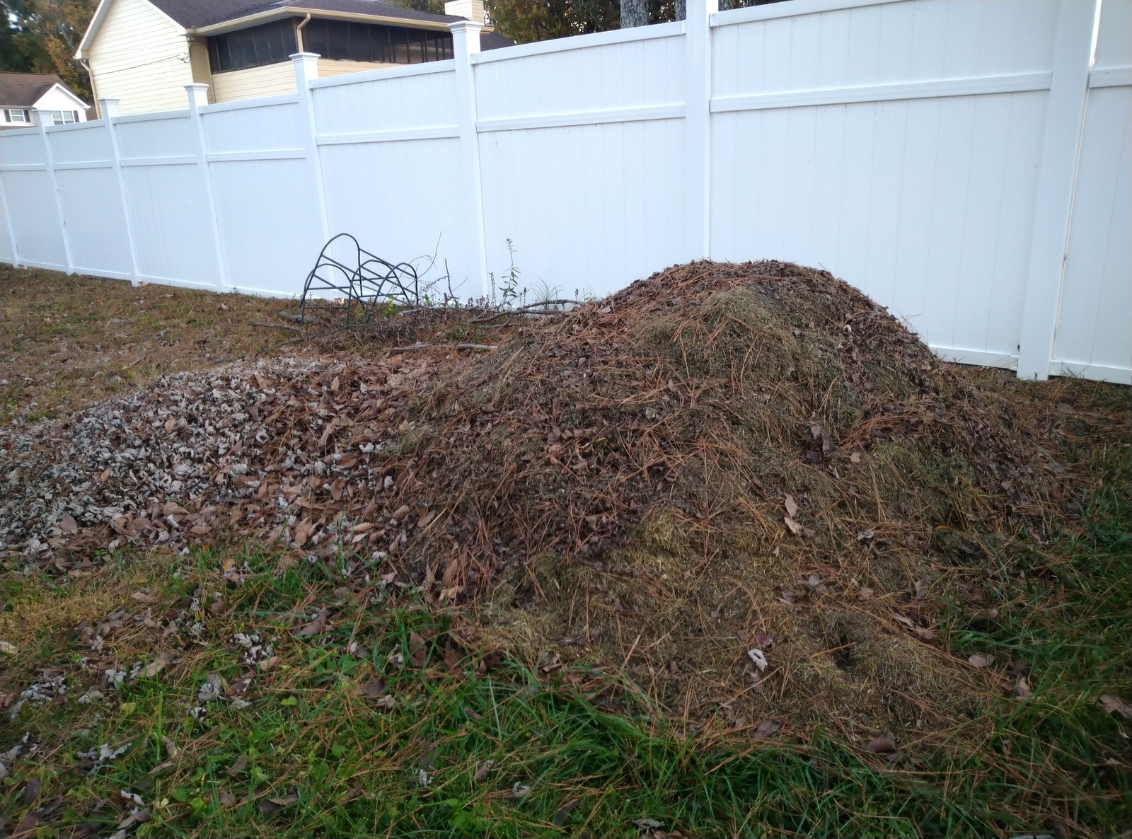 Pile of composting material outside bin