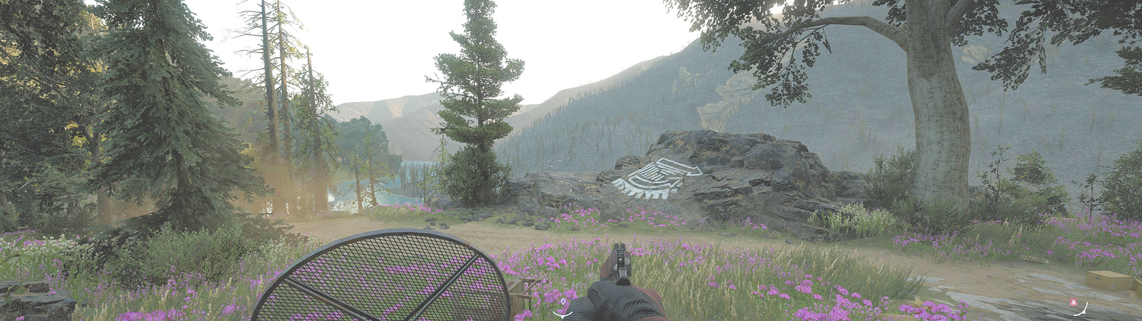 First person handgun drawn down with an overturned table, pink flowers and a line painting on a rock with river valley in background