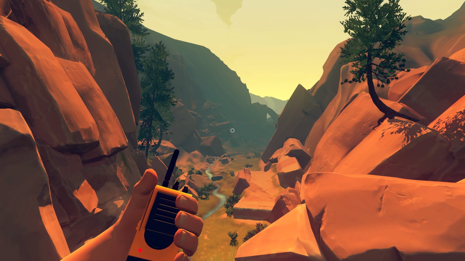 holding radio and looking into green valley midday