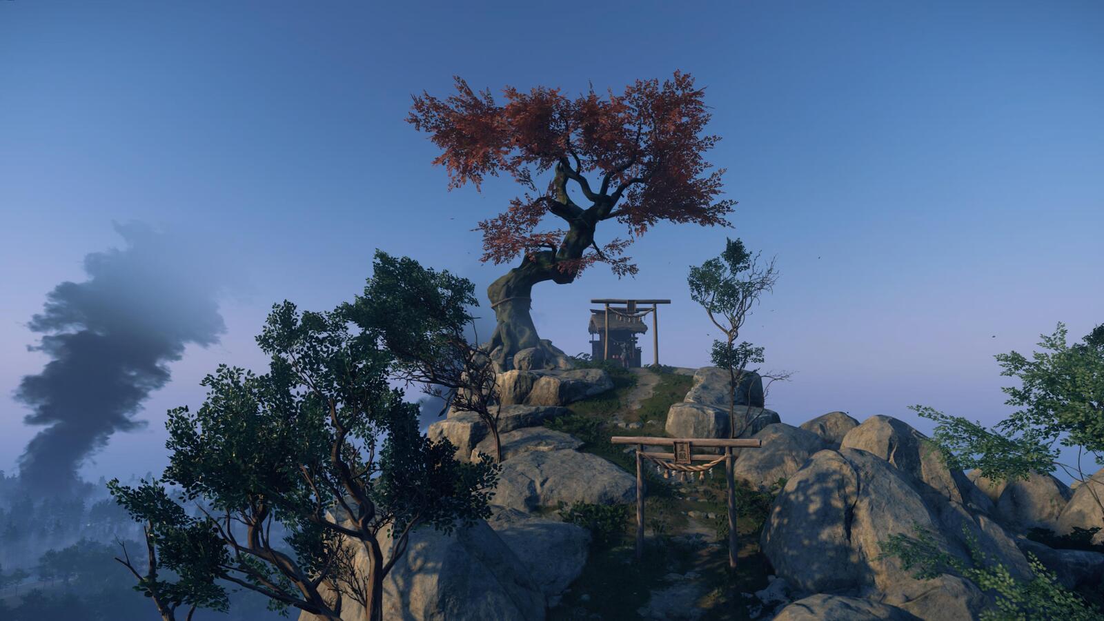 Shrine under a tree atop a hill