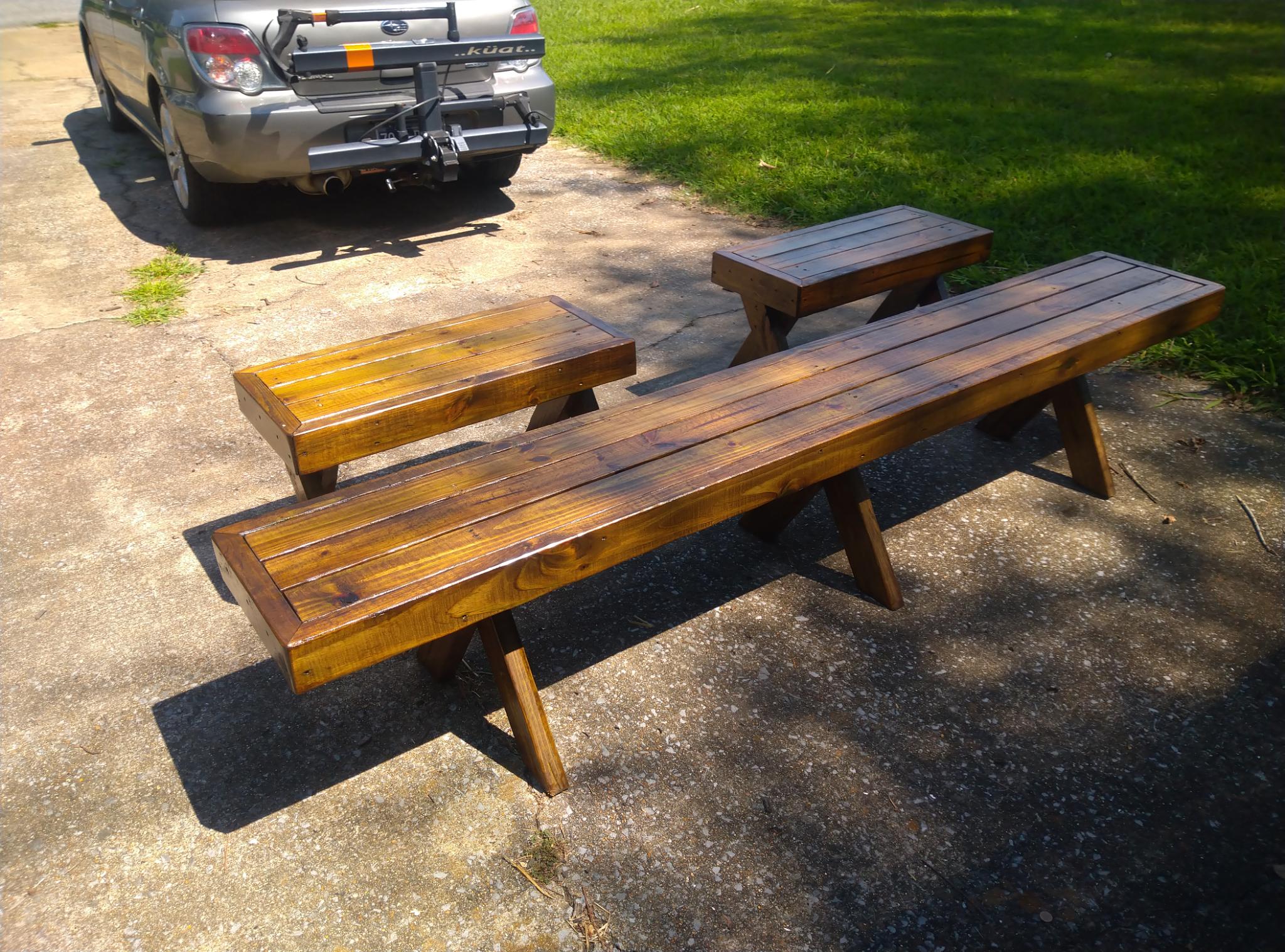 Three of the Finished Wooden Benches on a Concrete Driveway Behind My Car