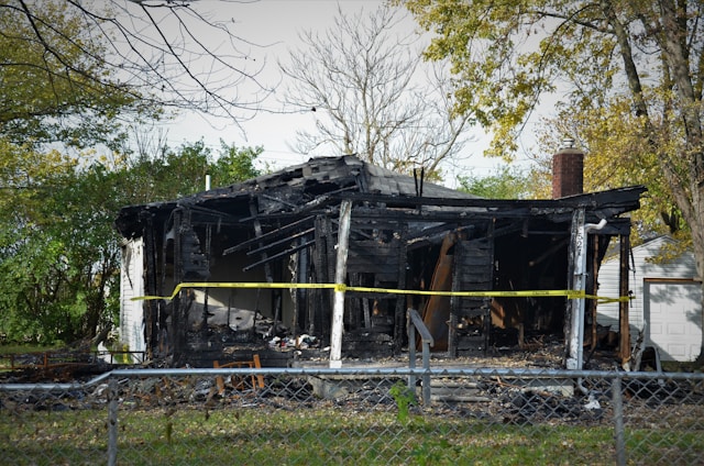 Burned out house with police caution tape in front