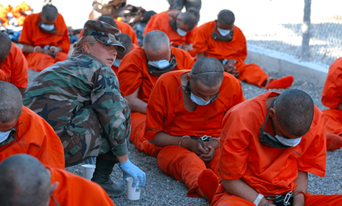 Prisoners wearing surgical masks at Guantánamo Bay