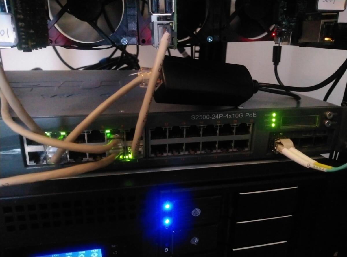 Close up image of PoE Switch and individual PoE injector under Pi Cluster
